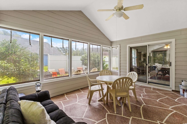 sunroom featuring a healthy amount of sunlight, ceiling fan, and lofted ceiling