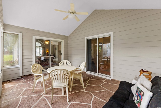 sunroom featuring ceiling fan and vaulted ceiling