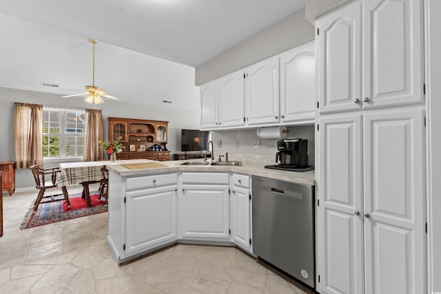 kitchen with white cabinets, kitchen peninsula, stainless steel dishwasher, and ceiling fan