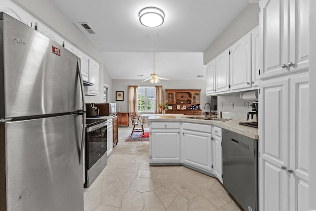 kitchen featuring ceiling fan, sink, white cabinetry, and stainless steel appliances