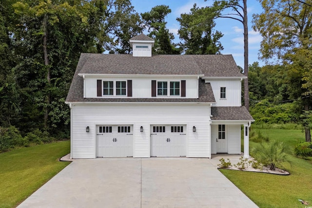 view of front of house featuring a front yard and a garage