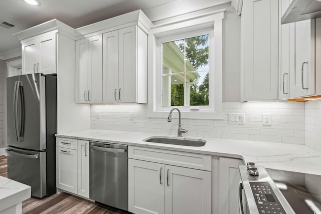 kitchen featuring dark hardwood / wood-style flooring, stainless steel appliances, sink, and white cabinetry