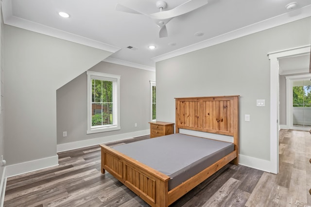 bedroom with ceiling fan, dark hardwood / wood-style floors, and ornamental molding