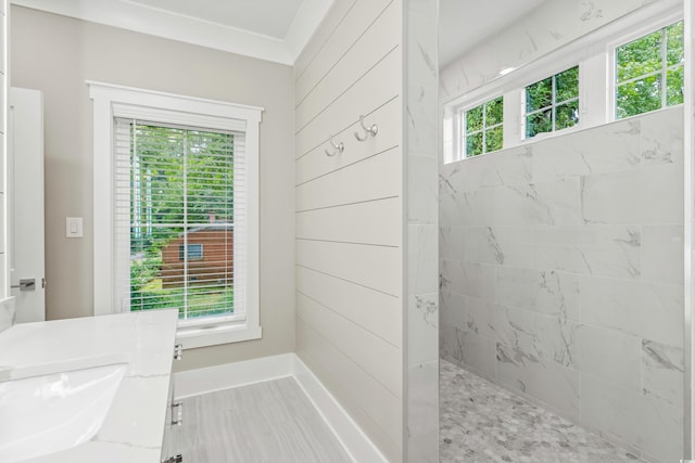 bathroom featuring tiled shower and plenty of natural light