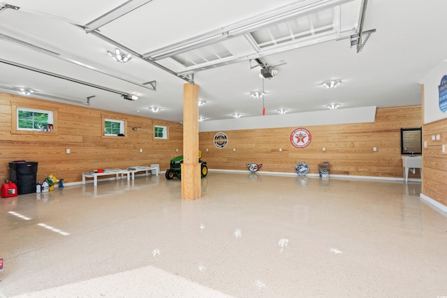 garage with a garage door opener and wooden walls