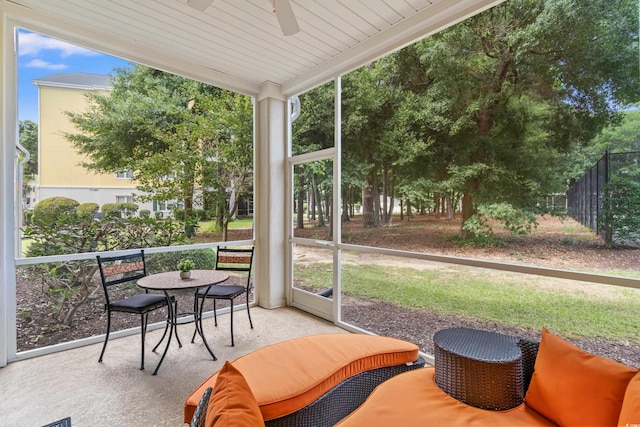 sunroom / solarium featuring ceiling fan