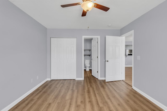 unfurnished bedroom featuring light wood-type flooring, ensuite bath, ceiling fan, and a closet