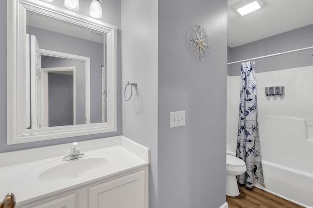 full bathroom with shower / bath combo, hardwood / wood-style floors, toilet, and vanity