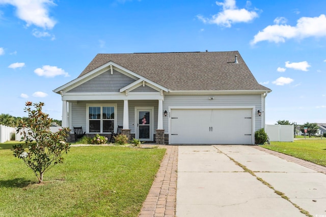 craftsman house featuring a porch, a garage, and a front lawn