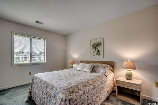 carpeted bedroom with a textured ceiling