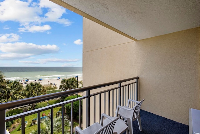 balcony with a view of the beach and a water view