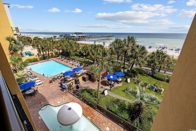 view of pool with a beach view and a water view