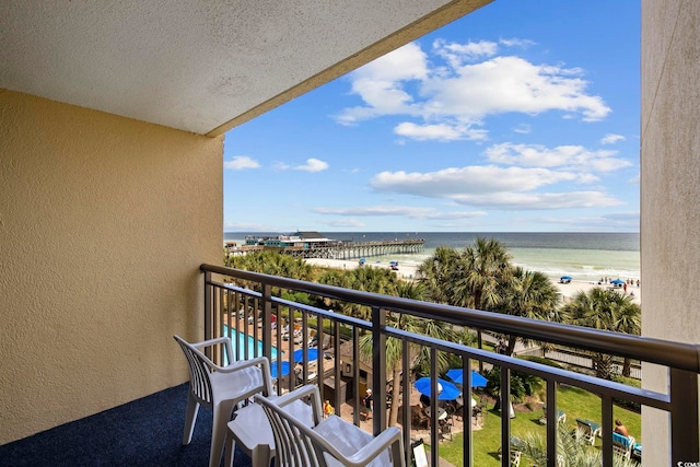 balcony with a view of the beach and a water view