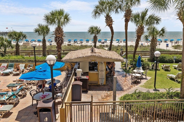 view of pool featuring a water view and a patio