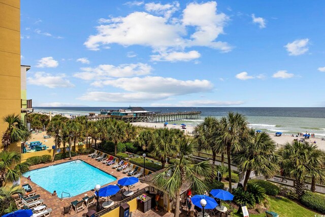 exterior space with a water view and a view of the beach