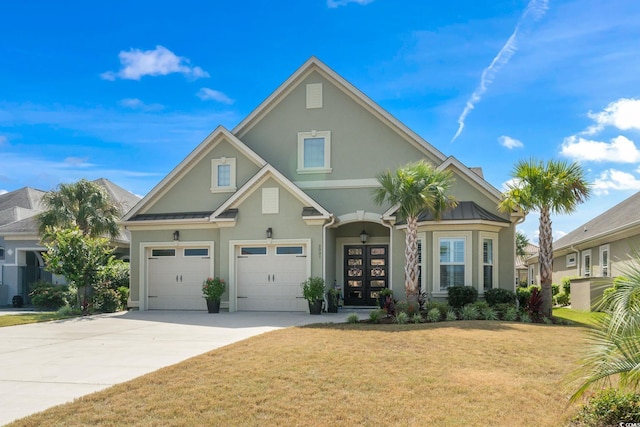 view of front of home with a front lawn and a garage