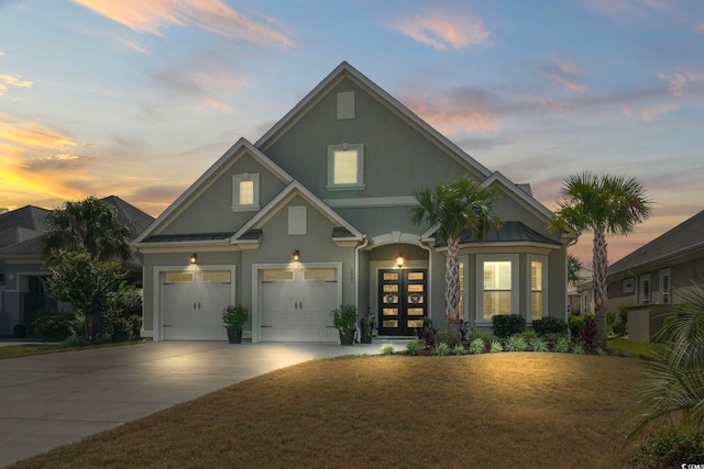 view of front facade featuring a yard and a garage