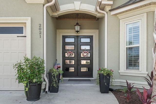 property entrance featuring french doors and a garage