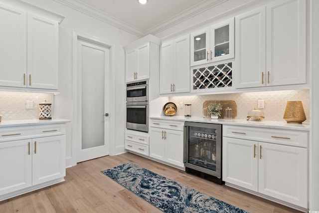 kitchen with white cabinetry, wine cooler, light hardwood / wood-style flooring, and backsplash