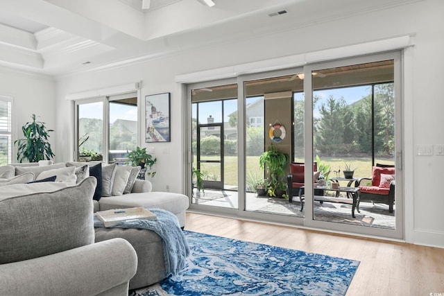 living room with crown molding, coffered ceiling, and hardwood / wood-style floors