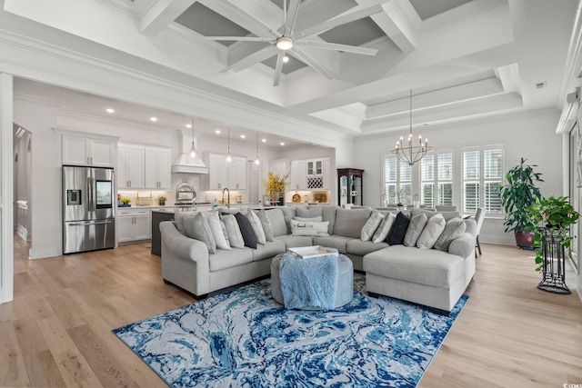 living room featuring ornamental molding, beamed ceiling, light hardwood / wood-style floors, a notable chandelier, and coffered ceiling