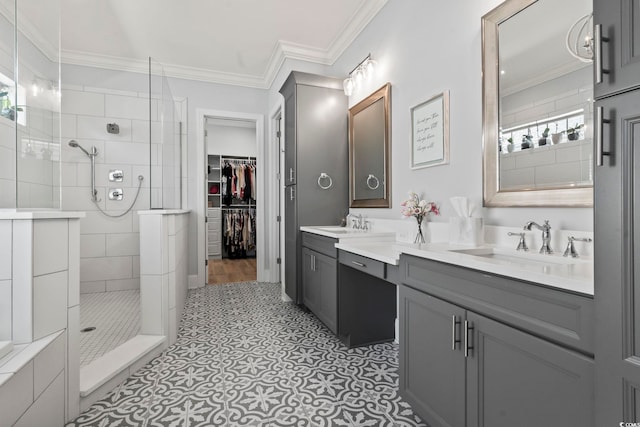 bathroom with vanity, ornamental molding, and tiled shower