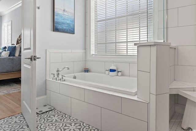 bathroom with tile patterned floors and tiled bath