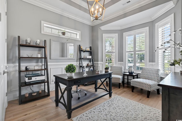 office area with ornamental molding, a healthy amount of sunlight, and light wood-type flooring