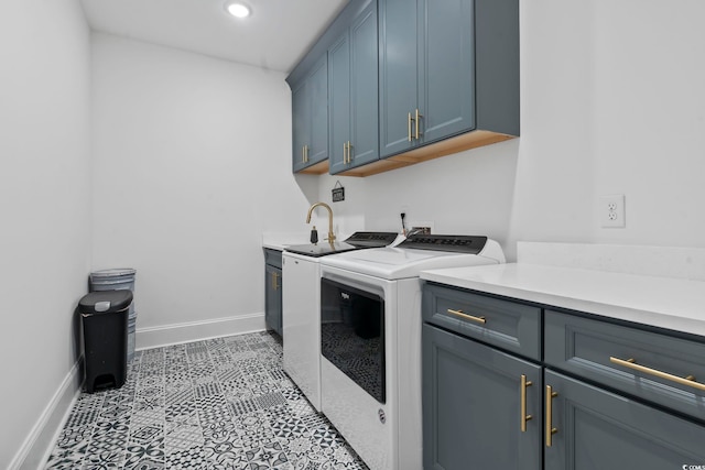 clothes washing area with light tile patterned flooring, cabinets, and washing machine and clothes dryer