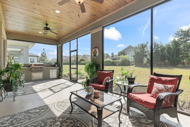 sunroom / solarium featuring wood ceiling and ceiling fan