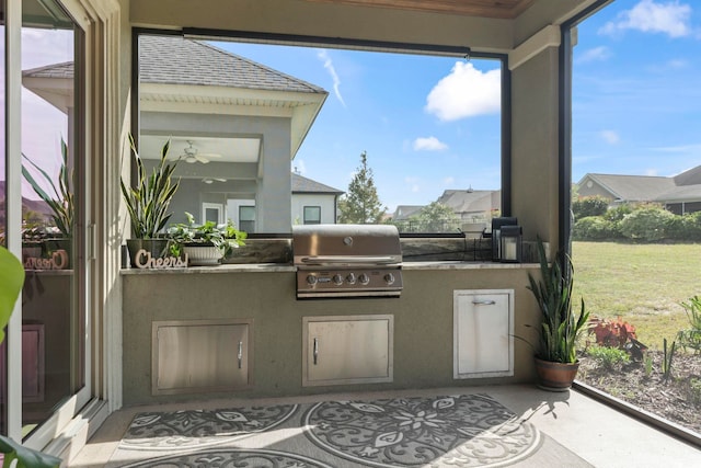 view of patio / terrace featuring exterior kitchen and a grill