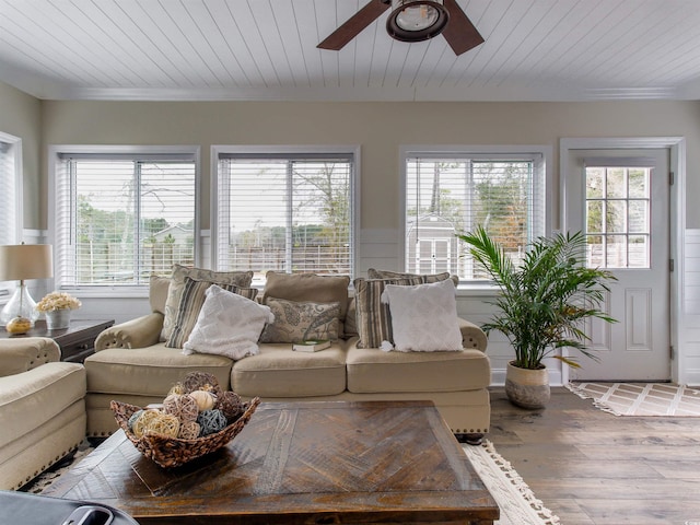 living area with ornamental molding, wood ceiling, ceiling fan, and wood finished floors