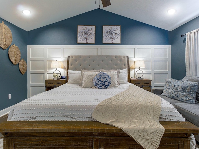 bedroom with lofted ceiling and a decorative wall