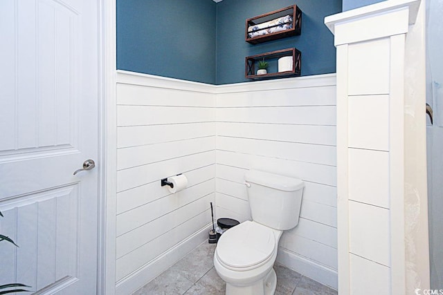 bathroom featuring wainscoting, toilet, and tile patterned floors