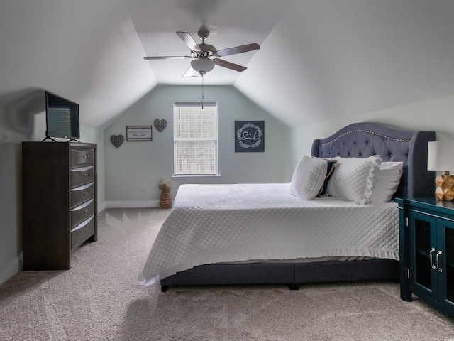 carpeted bedroom with ceiling fan, baseboards, and vaulted ceiling