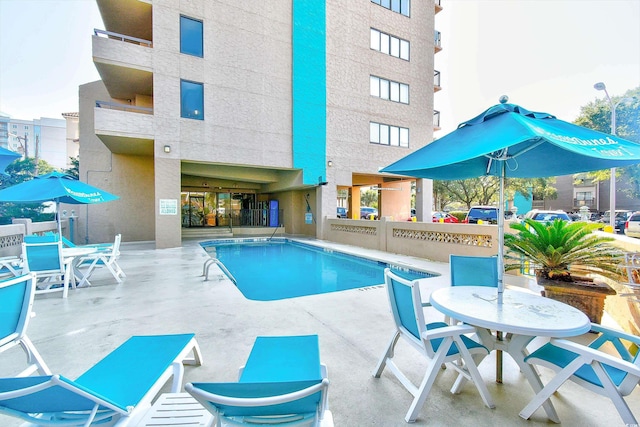 view of swimming pool featuring a patio area