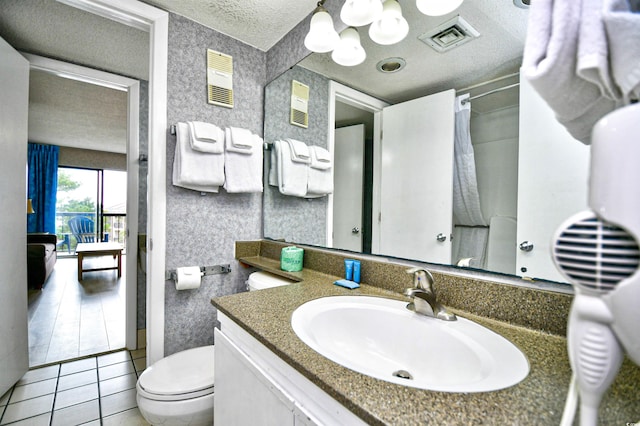 bathroom featuring vanity, a textured ceiling, a chandelier, tile patterned floors, and toilet