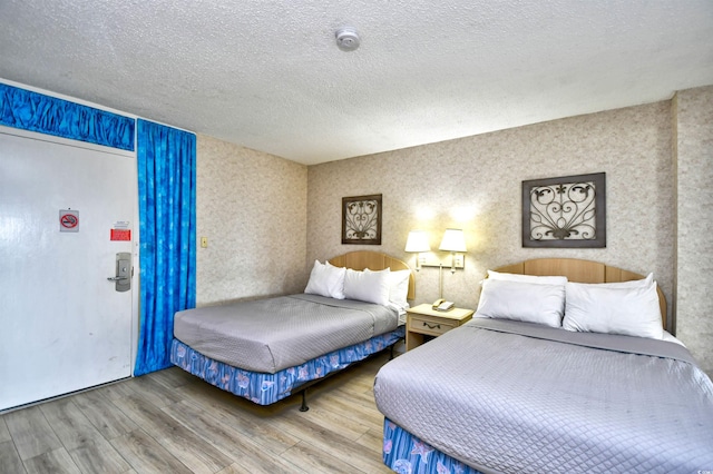 bedroom featuring a textured ceiling and hardwood / wood-style floors