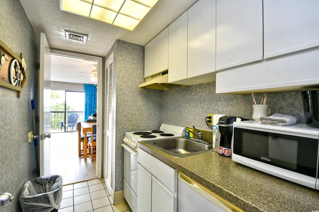 kitchen featuring sink, white cabinets, white appliances, light tile patterned floors, and ceiling fan