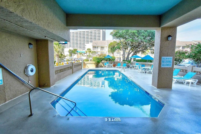 view of swimming pool with a patio area