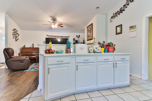 kitchen featuring white cabinetry, ceiling fan, and light tile patterned floors