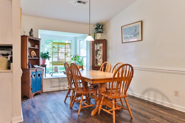 dining room featuring vaulted ceiling and dark hardwood / wood-style floors