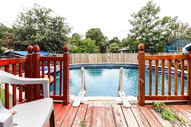 view of swimming pool with a wooden deck