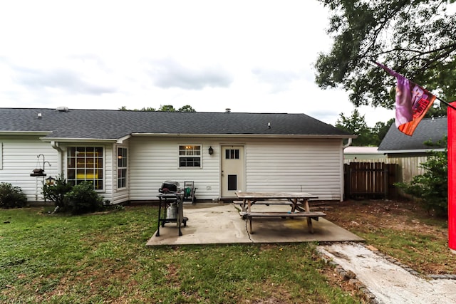 rear view of property with a patio and a yard