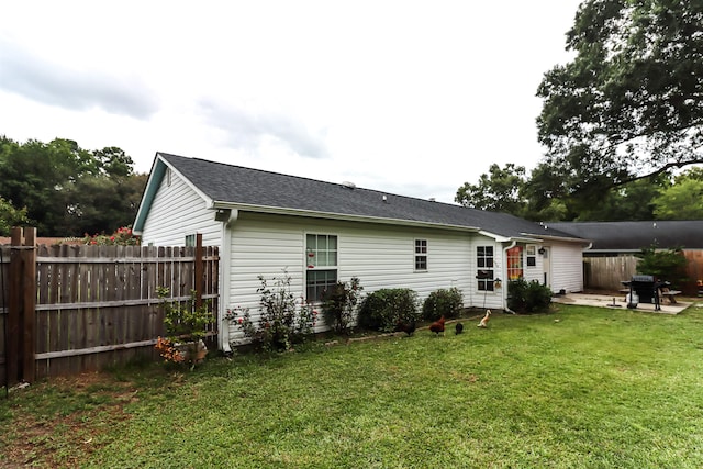 back of house with a yard and a patio area