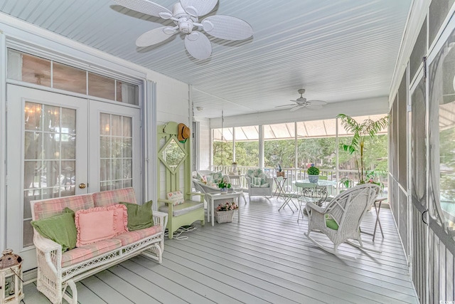 sunroom / solarium featuring french doors and ceiling fan