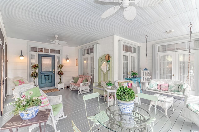 sunroom featuring ceiling fan and french doors