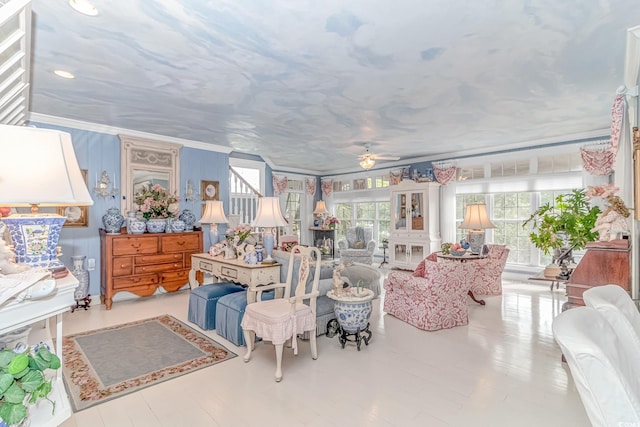 interior space with ceiling fan and ornamental molding