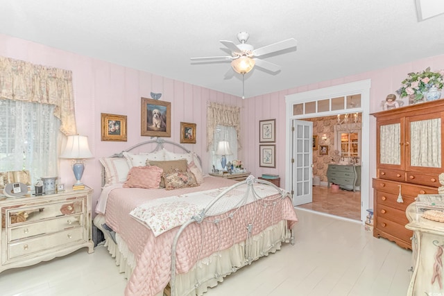 bedroom featuring ceiling fan and french doors