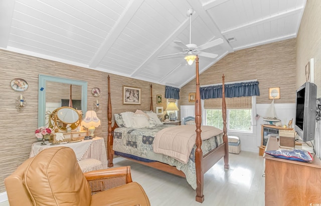 bedroom featuring lofted ceiling with beams, light hardwood / wood-style flooring, and ceiling fan